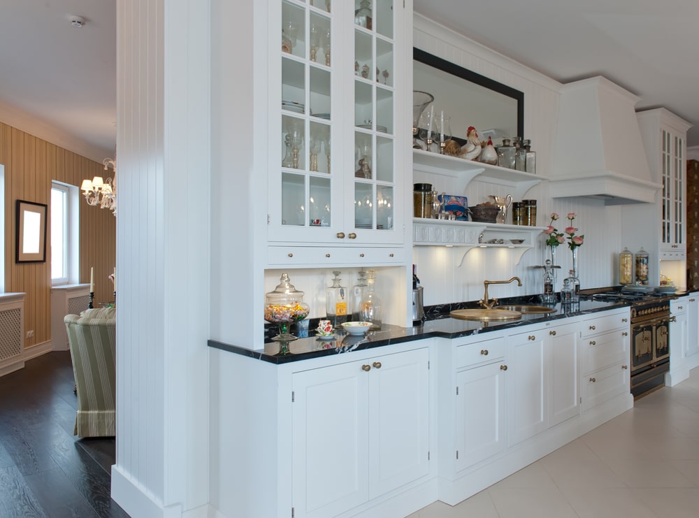 white modern kitchen hutch with black granite countertop