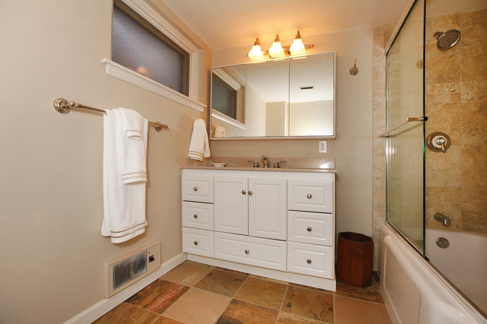 Large medicine cabinet with mirrors above the bathroom vanity