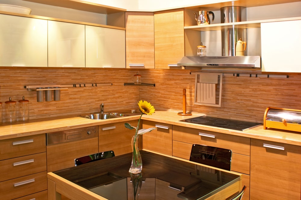 warm tone plywood kitchen with black granite counter