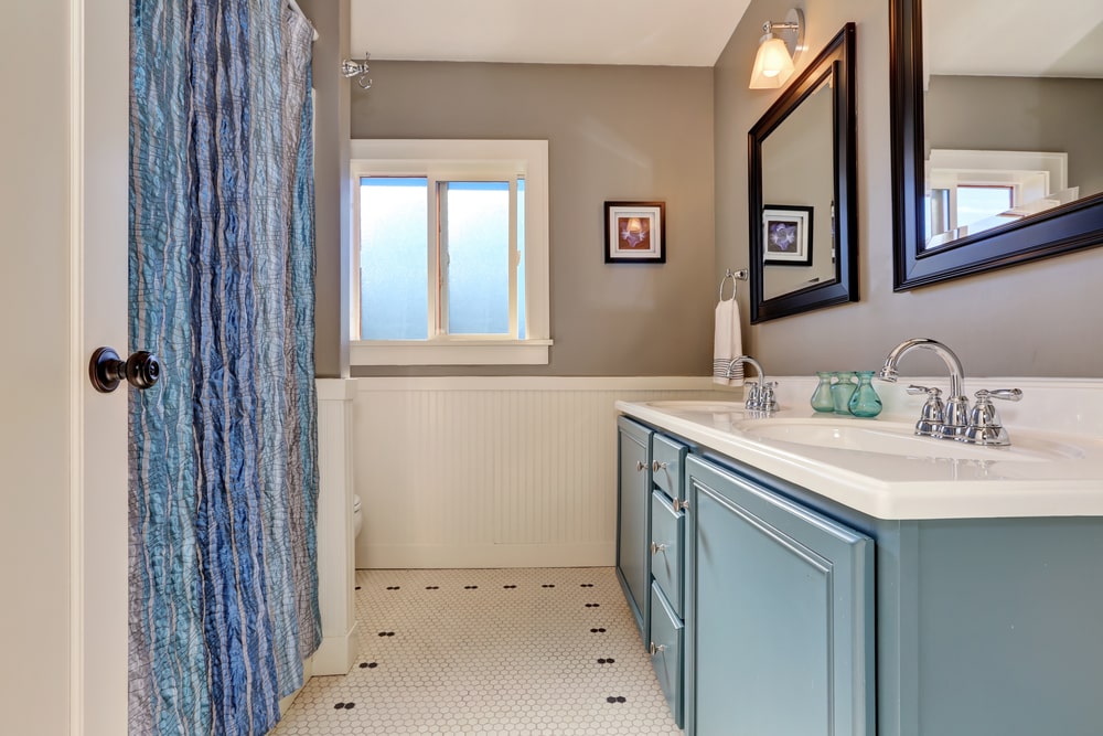 pale blue bathroom cabinet against grey walls
