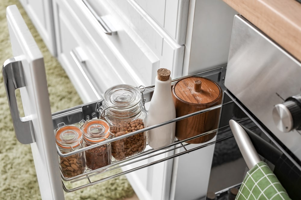 Tall narrow pull-out kitchen cabinet with jars