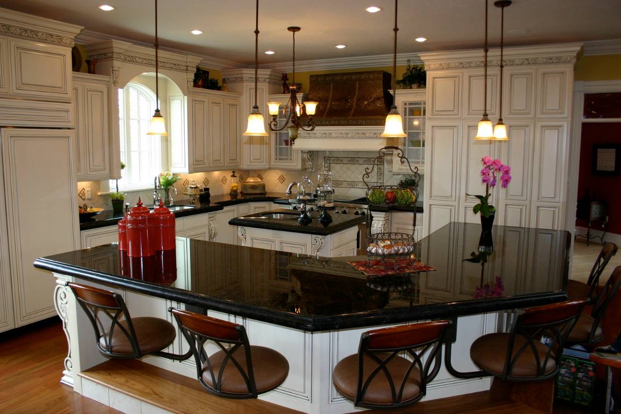 White kitchen cabinets with black marble countertops 